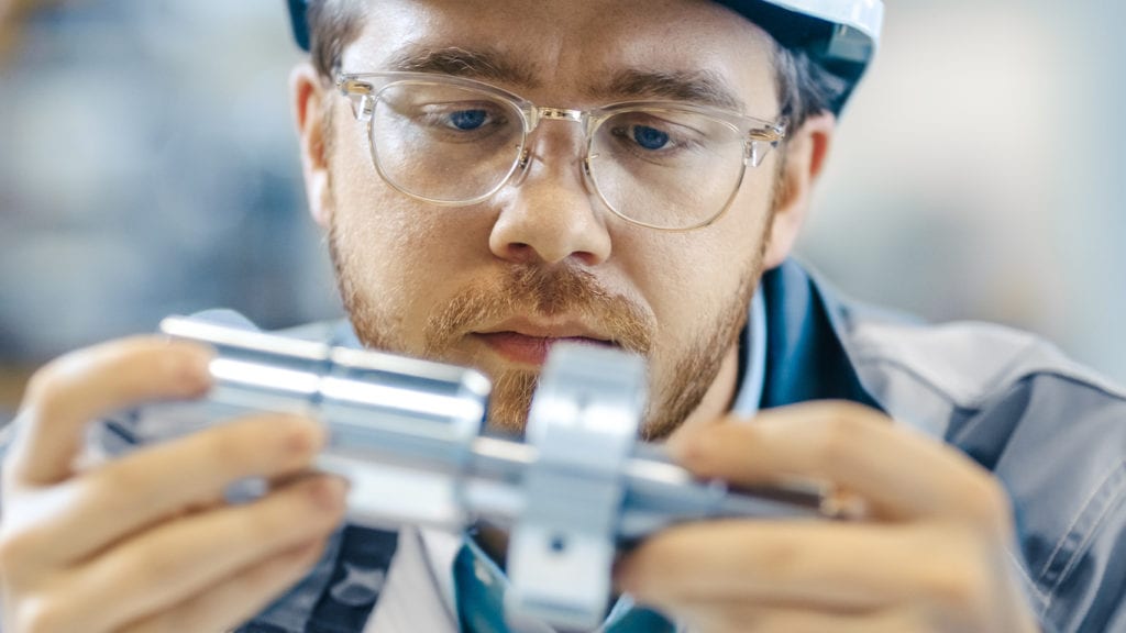 A medical device project engineer holding a tool
